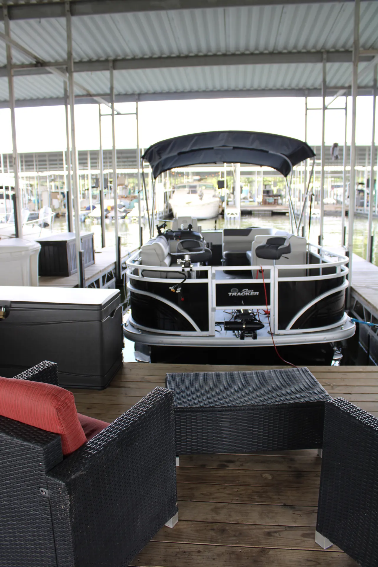 A pontoon boat in its covered slip on B Dock